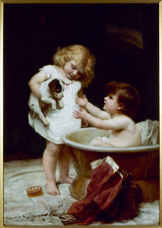 small boy in a bath tub reaching for a puppy that a small girl standing next to him is holding. There is a bar or Pears soap by her feet