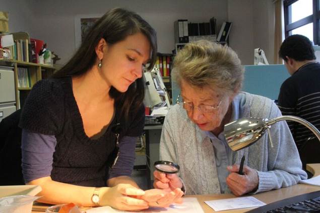 PhD student Denise identifying Roman coins
