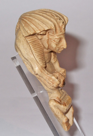 Replica of an ivory sphinx with the head of pharaoh crushing a captive