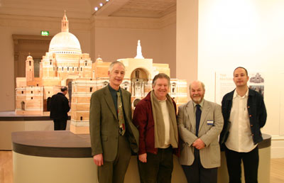 4 men in front of cathedral model