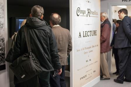 Photograph of display with visitors and entrance to Congo Atrocities lecture