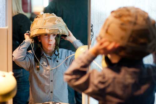 Image of boy trying on helmet