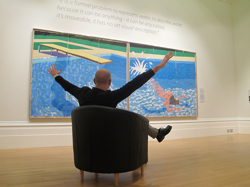 Picture of a man in a seat viewing Hockney's 'Le Plongeur'