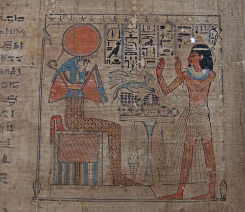 Detail of the papyrus showing Amenkhau standing up and holding his hands up in adoration before before the falcon-headed god Ra-Horakhty seated on a throne.
