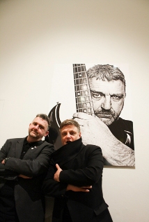 Photo of Phil next to Rankin in Walker Art Gallery in front of a large photograph of Phil. 