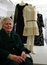 lady in front of display of clothing