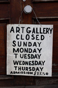 'Art gallery closed' sign hanging on a door knob