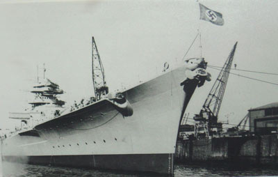 black and white photo of a large ship with a swastika flag