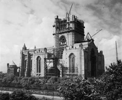 photo of partly built cathedral with cranes and scaffolding