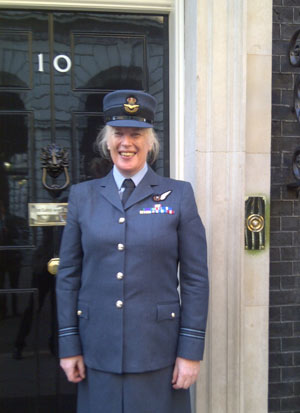 Caroline Paige in Royal Air Force uniform at the door of number 10