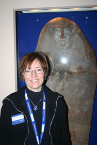 Carolyn Routledge in front of a stone artefact in the Egypt gallery.