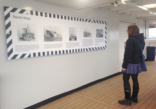ferry passenger looking at dazzle ship display