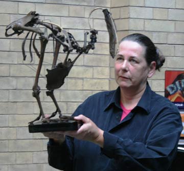 Woman holding a brown Dodo skeleton