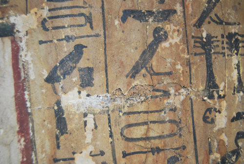 Close-up shot of the hieroglyphs: notice the flaking paint and areas of loss.