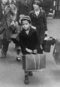 archive photo of a young Black evacuee holding a suitcase