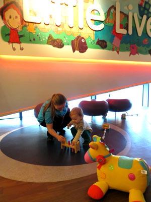 mother and child playing with toys at the museum