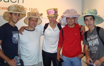 A group of male students in ladies hats