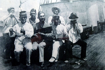 Archive photo of sailors playing musical instruments on the deck of a ship