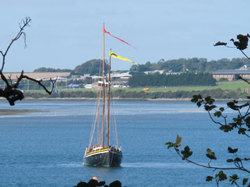 Twin masted sailing ship in bay 