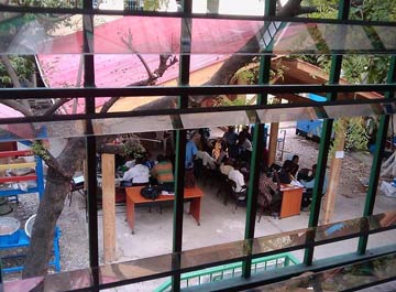 relief workers in their temporary office in a school yard