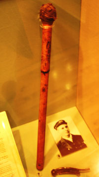 A wooden staff in a display case