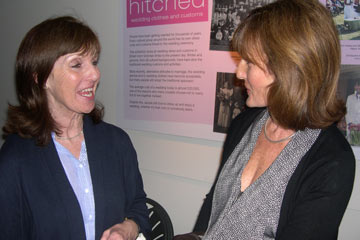 two women chatting at an exhibition