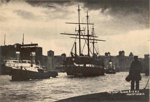 Photo of a sailing ship being towed into docks