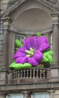 Giant purple inflatable flower on a balcony