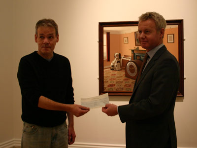 Two men holding a cheque