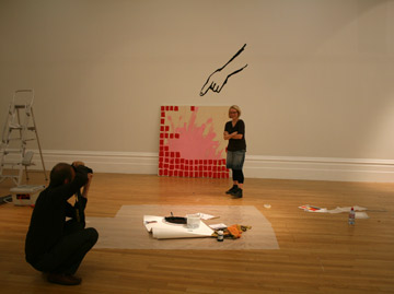 Artist with her work at press call
