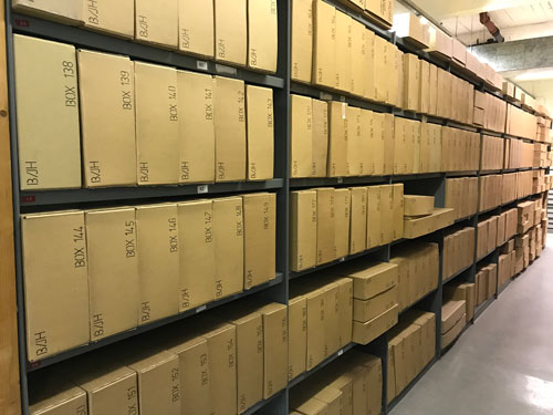 long rows of archive boxes on shelves