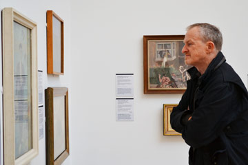 John Kirby looking at paintings in the Walker
