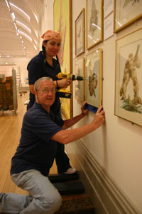 Handling team attaching pictures to wall 