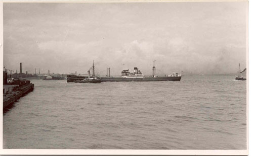 archive photo of a ship and a tug