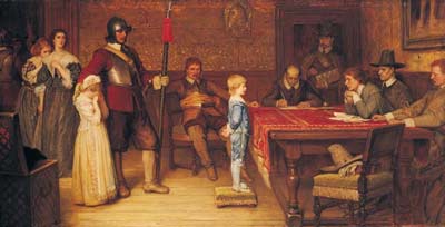 Boy standing in front of a table of men
