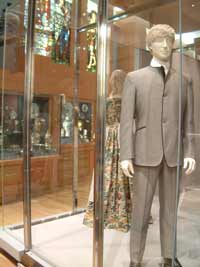A mannequin wearing a John Lennon Beatle suit
