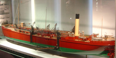 photograph of a model of a large red ship