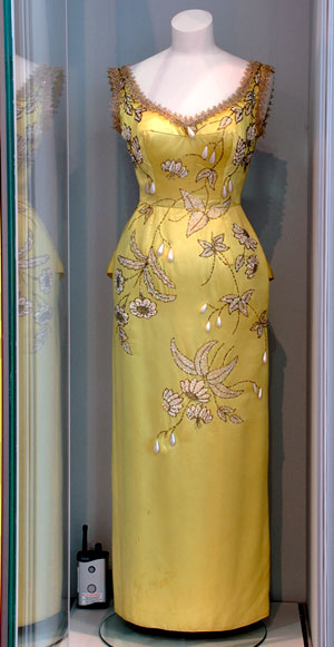 dress decorated with elaboare embroidery, in museum display