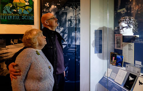 people looking at poetry display in museum