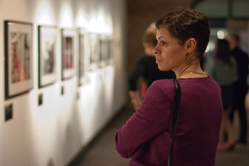 woman looking at framed photographs