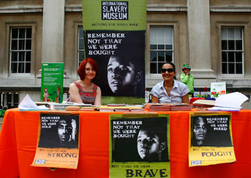 2 women at a stall with International Slavery Museum publicity