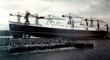 archive photo of crowds watching the launch of a huge ship