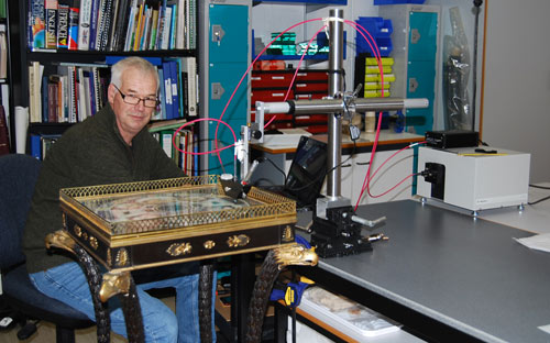 Man with technical equipment and a decorative table