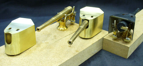 three newly made brass model guns, before they were painted