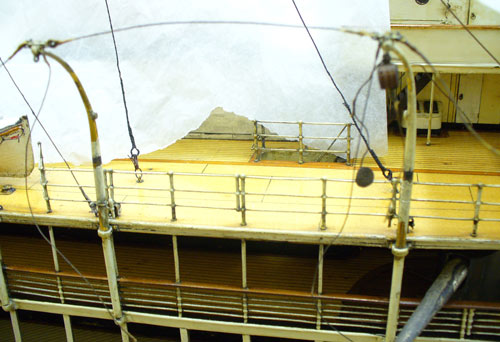 detail of empty davits on the deck of a model ship
