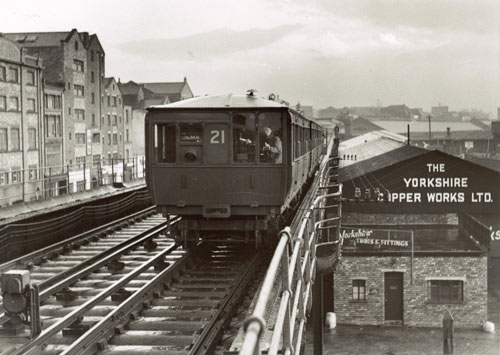 train on elevated rail tracks above the roofs of buildings