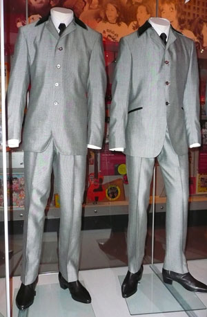 two grey Beatles suits displayed on mannequins