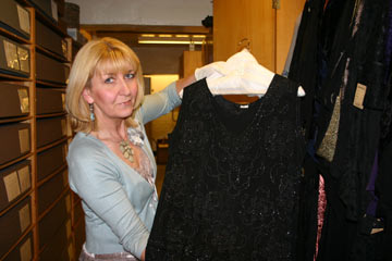 Woman holding a sparkly black dress