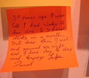 An orange post-it note left by a visitor to the Rankin exhibtion expressing emotion
