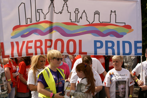 people under a large Liverpool Pride banner